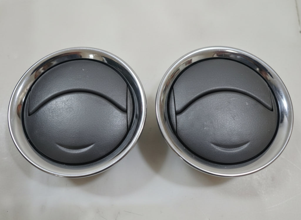 Two metal bowls with a black interior on a light gray background