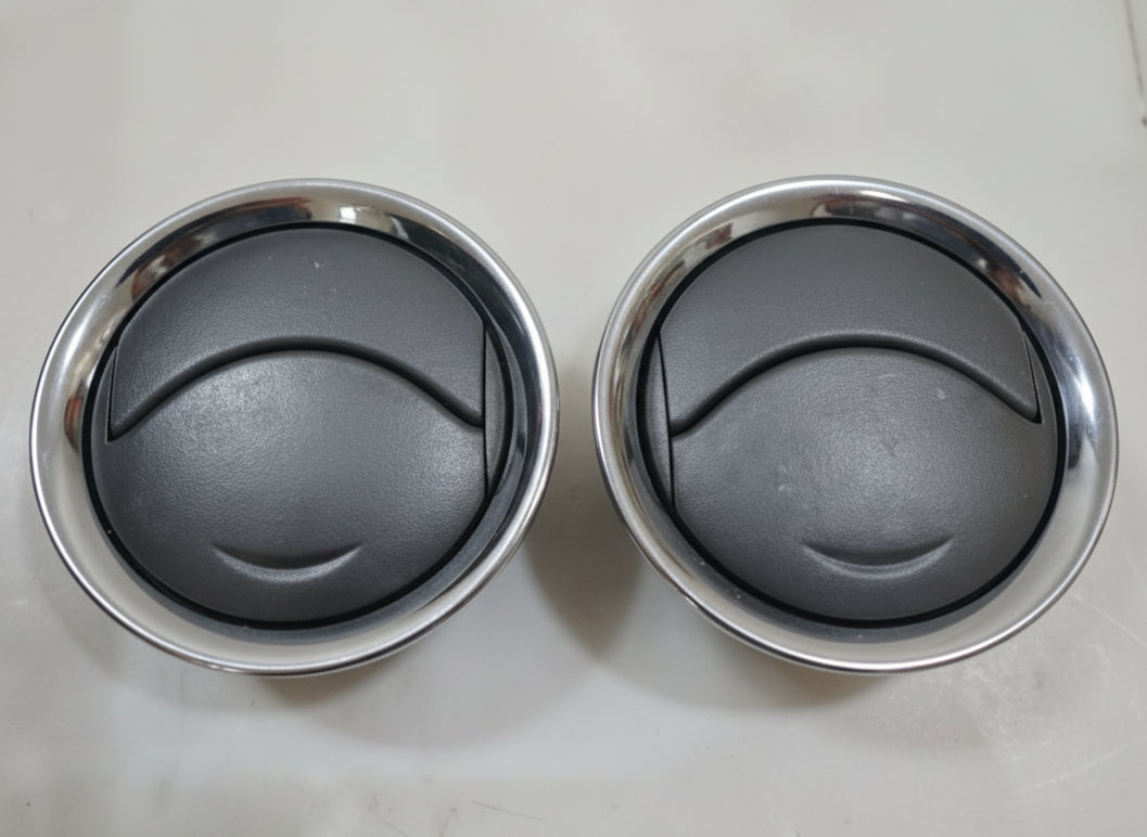 Two metal bowls with a black interior on a light gray background