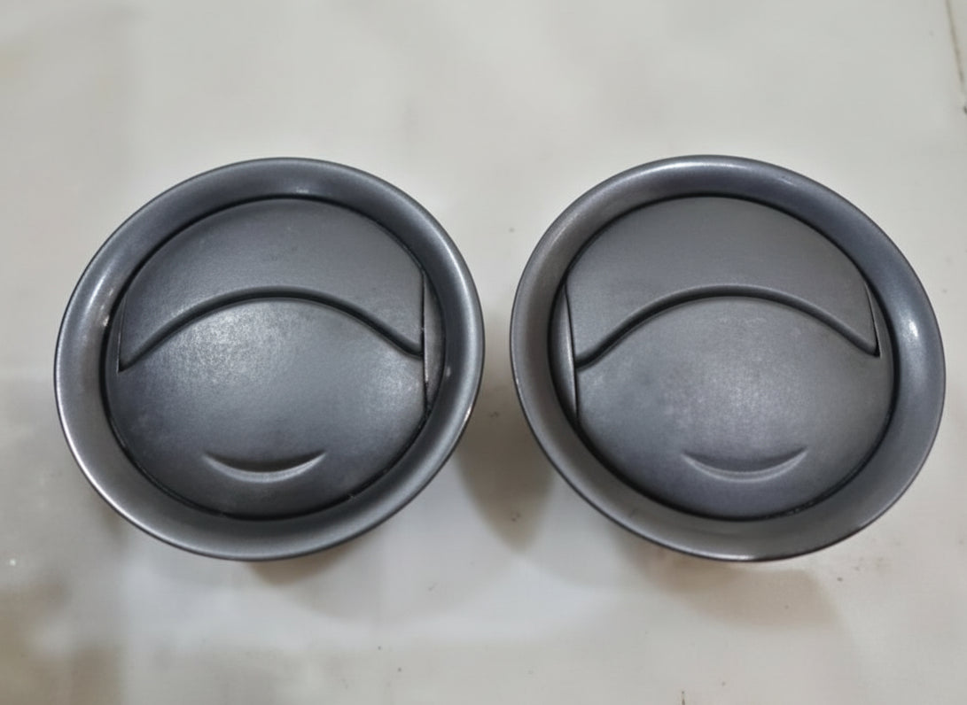 Two metal bowls with a black interior on a light gray background