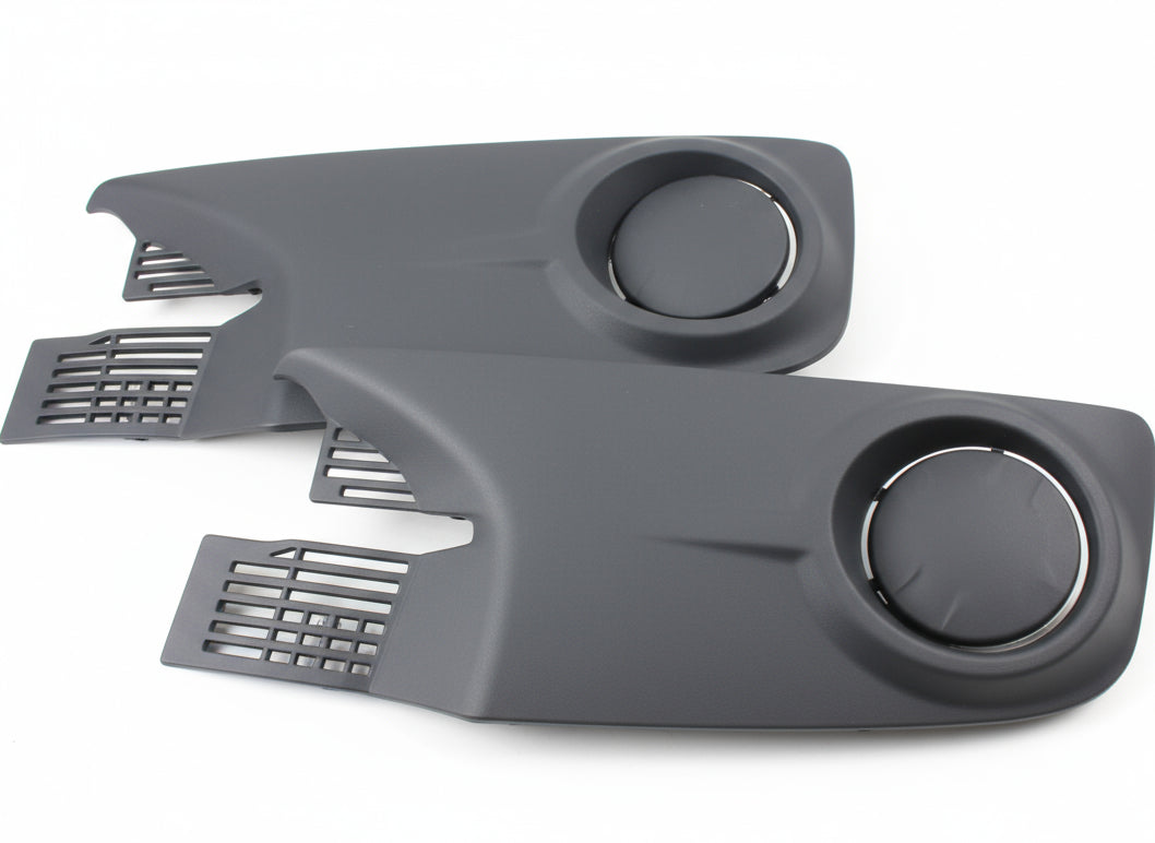 Two gray plastic parts with circular cutouts on a textured surface