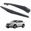 Two car wiper blades with a white SUV in the background and a red NDE label.