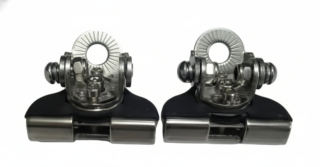 Two metallic clip-on devices with intricate designs on a light gray background