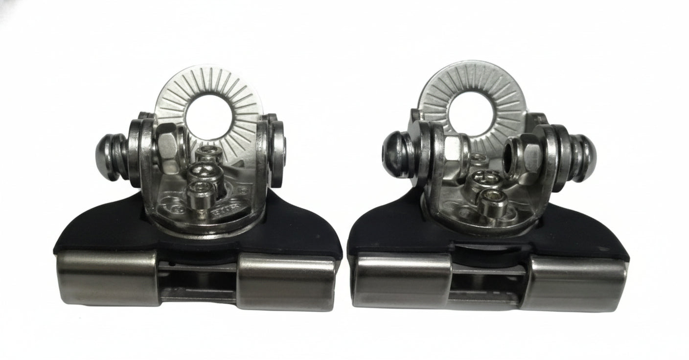 Two metallic clip-on devices with intricate designs on a light gray background