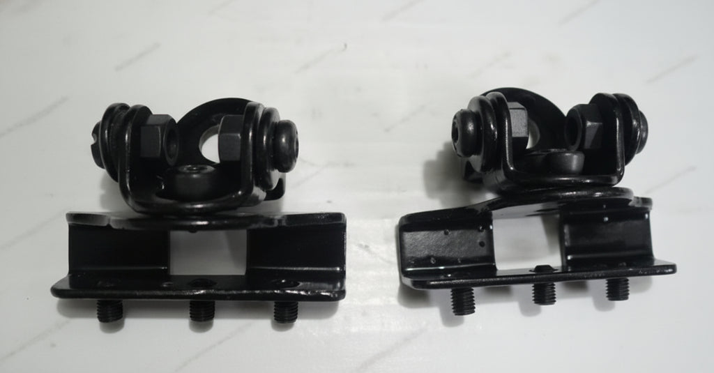 Two black mechanical components on a white background