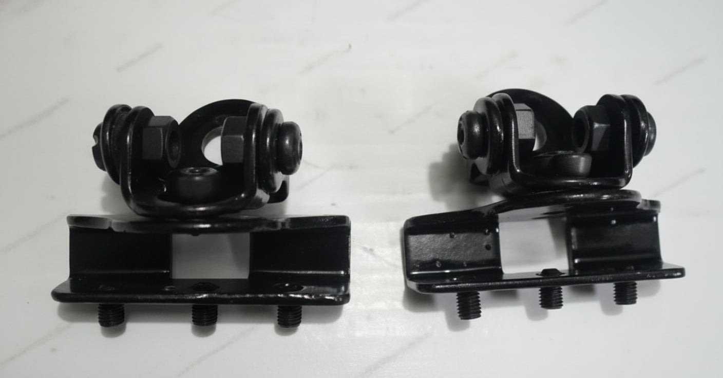 Two black mechanical components on a white background