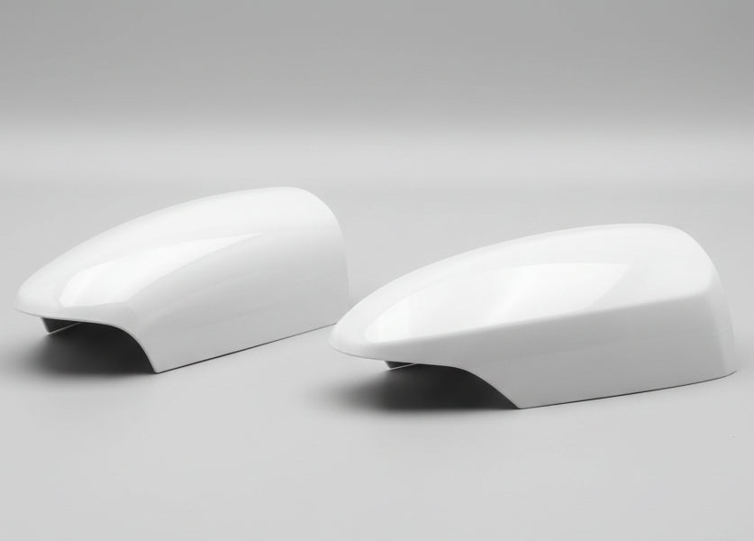 Two car mirror covers on a white background