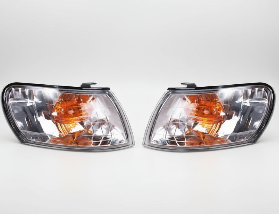 Pair of car headlights with clear and amber lenses.