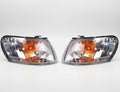 Pair of car headlights with clear and amber lenses.