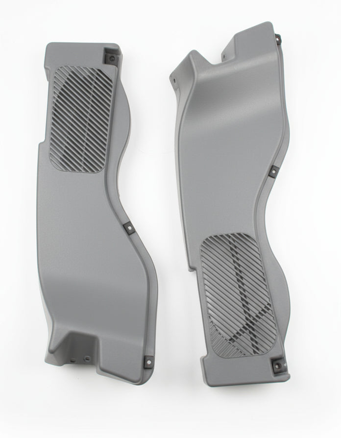 Two gray car floor mats on a wooden floor.