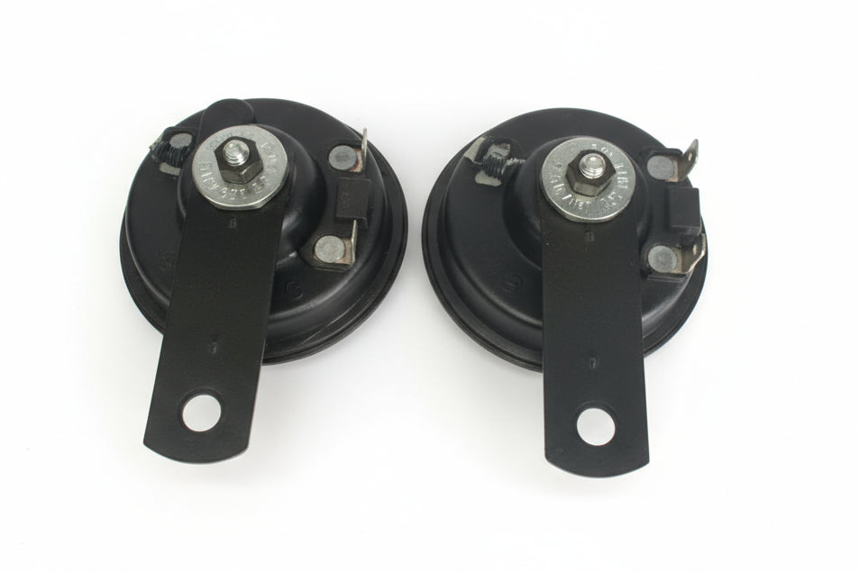 Two black mechanical components on a white background