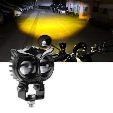 Black off-road light with yellow glow on a dark background