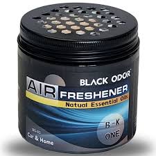 Black odor air freshener with visible brand name on a dark background
