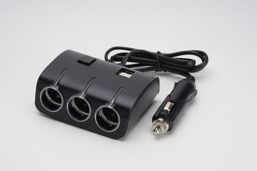 Black car charger with multiple outlets and a cable on a white background