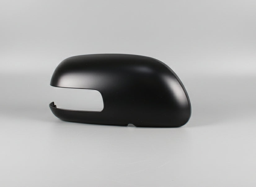 Black car mirror on a white background with a silver car for scale.