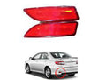 Red car tail light on a white background with a white car for scale.